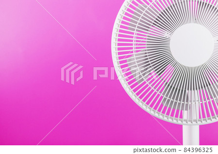Electric fan in white with a modern design for cooling the room on a pink background. 84396325