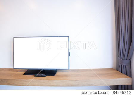 Monitor led television or TV with empty white screen beside the window on brick wall interior room in hotel 84396740