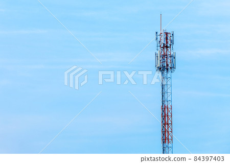Mobile station receiver antenna tower with fluffy clouds blue sky daylight background. 84397403