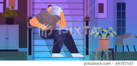 addicted man using digital gadget guy active in social networks digital addiction concept living room interior addicted man using digital gadget guy active in social networks digital addiction concept living room interior 84397587