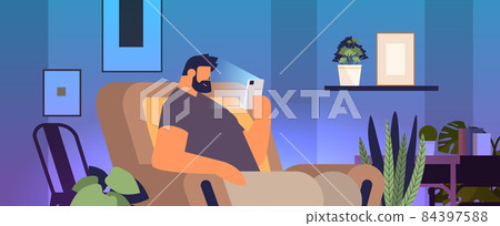addicted man using digital gadget guy active in social networks digital addiction concept living room interior addicted man using digital gadget guy active in social networks digital addiction concept living room interior 84397588