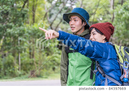 Young couple enjoying a hike Young couple enjoying a hike 84397669