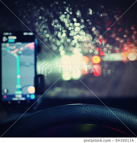 Dangerous winter season with snow on the road. The interior of the car from the driver's point of view - dangerous evening traffic in bad weather. Dangerous winter season with snow on the road. The interior of the car from the driver's point of view - dangerous evening traffic in bad weather. 84399114