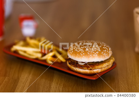 Burger with french fries on a wooden background. Burger with french fries on a wooden background. 84400380