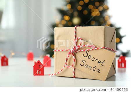 Secret Santa and Christmas composition on white wooden table Secret Santa and Christmas composition on white wooden table 84400463