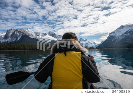 Traveler man canoeing with Canadian Rockies on Maligne lake at Jasper national park Traveler man canoeing with Canadian Rockies on Maligne lake at Jasper national park 84400819