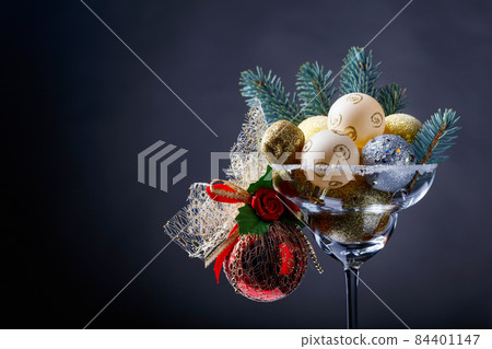 Christmas balls in wineglass . Christmas balls in wineglass . 84401147