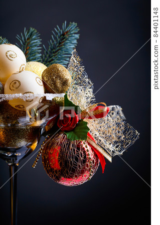 Christmas balls in wineglass . Christmas balls in wineglass . 84401148