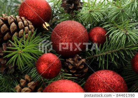 Spruce branches with cones and baubles, close up Spruce branches with cones and baubles, close up 84401390