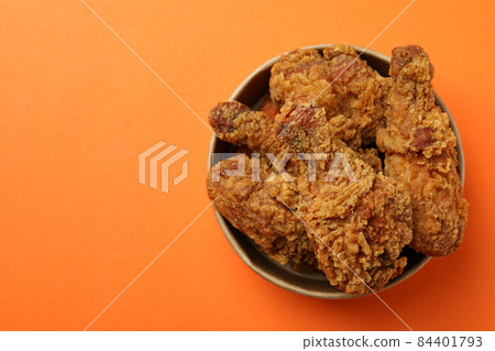 Bucket with fried chicken on orange background 84401793