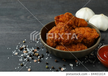 Concept of tasty eating with fried chicken on dark wooden background 84401814