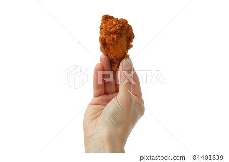 Female hand holds fried chicken, isolated on white background 84401839