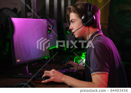 Cyber sport. Fully concentrated professional cybersport player playing important match 84403456