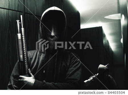 Group of criminal men in a hidden mask with a shotgun 84403504