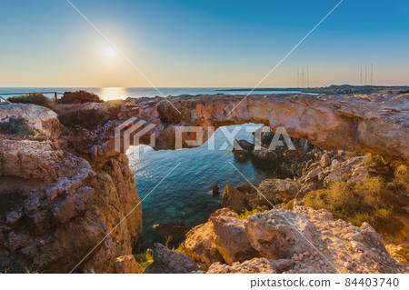 Famous stone Sin Bridge at sunrise in Ayia Napa Cyprus Famous stone Sin Bridge at sunrise in Ayia Napa Cyprus 84403740