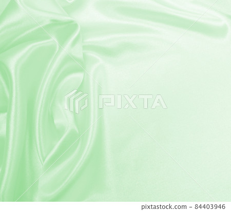 Smooth elegant green silk or satin luxury cloth texture as abstract background. Luxurious background design 84403946