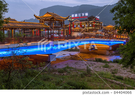 Wulingyuan, China - May 27, 2018: Town Wulingyuan at sunset in Tianzi Avatar mountains nature park Wulingyuan, China - May 27, 2018: Town Wulingyuan at sunset in Tianzi Avatar mountains nature park 84404066