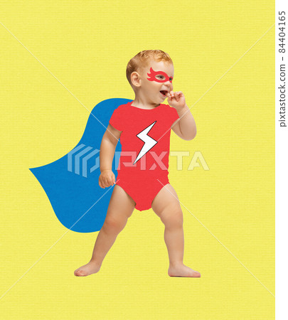 Contemporary art collage of little boy, playful child wearing bodysuit and cloak like superman isolated over yellow background 84404165