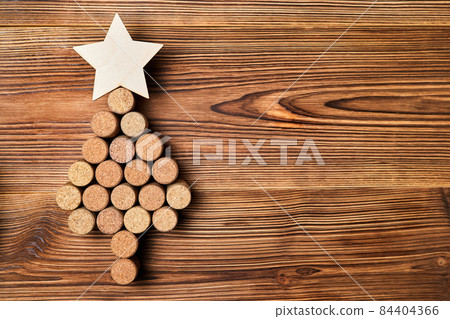 Christmas tree from wine corks with a star on top on a wooden background 84404366