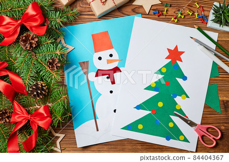 A Christmas greeting cards from colored paper made by a child A Christmas greeting cards from colored paper made by a child 84404367
