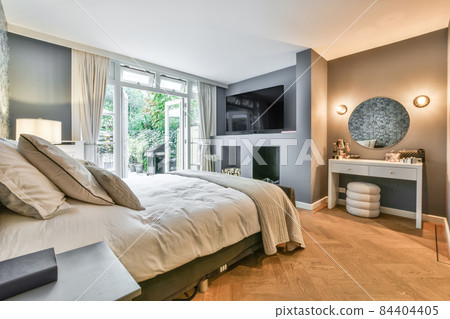 Stylish interior of contemporary bedroom with comfortable furniture Stylish interior of contemporary bedroom with comfortable furniture 84404405