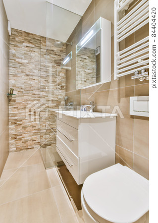 Interior of small clean restroom in miniature style 84404420
