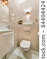 Interior of small clean restroom in miniature style 84404424
