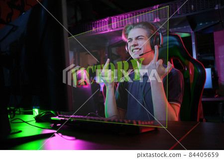Professional young caucasian gamer playing online on his PC. He upset because of losing the game Professional young caucasian gamer playing online on his PC. He upset because of losing the game 84405659