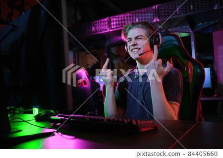 Professional young caucasian gamer playing online on his PC. He upset because of losing the game 84405660