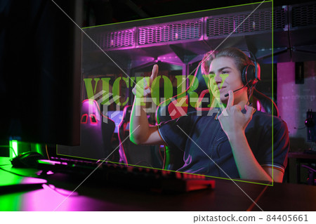 Professional young caucasian gamer playing online on his PC. He upset because of losing the game 84405661