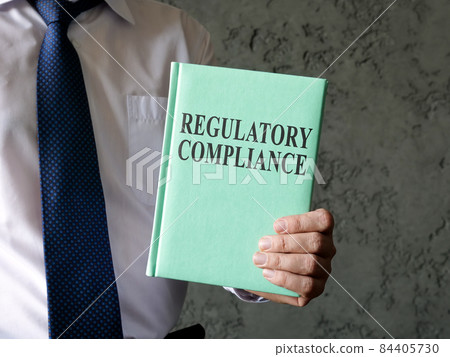 A man propose book about regulatory compliance. 84405730