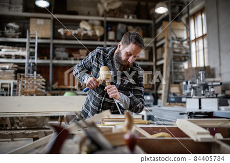 Portrait of mature male carpenter working on his product. Small business concept. 84405784