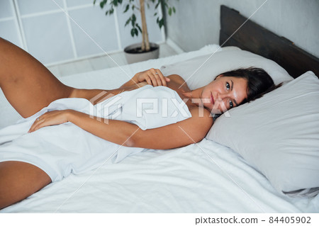 beautiful woman in blue lingerie in the bedroom on the bed 84405902