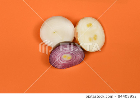 Three sliced onion of different colors (red, yellow and white) isolated on orange background. High resolution photo. Full depth of field. 84405952