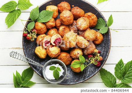Curd donuts with raspberries Curd donuts with raspberries 84406944