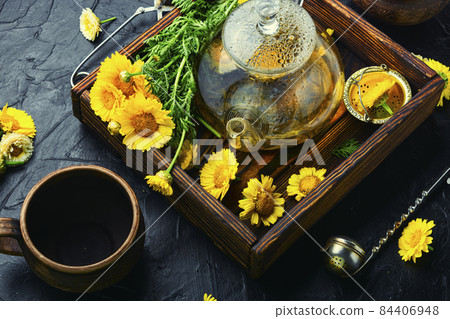 Glass teapot with flower tea,herbalism Glass teapot with flower tea,herbalism 84406948