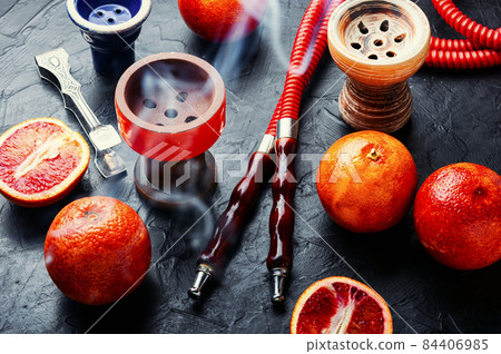 Traditional oriental hookah with orange tobacco 84406985