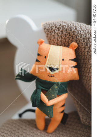 cute soft toy tiger - symbol of 2022, oriental calendar concept cute soft toy tiger - symbol of 2022, oriental calendar concept 84407710