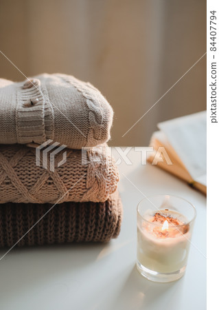 cozy home atmosphere and still life with coffee, candle and sweaters cozy home atmosphere and still life with coffee, candle and sweaters 84407794