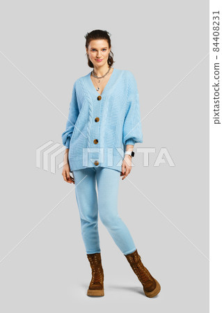 Full length portrait of beautiful woman in light blue warm knitted tracksuit Full length portrait of beautiful woman in light blue warm knitted tracksuit 84408231