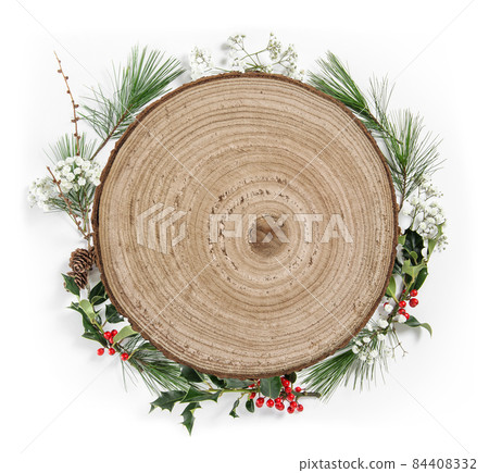 Christmas flat lay. Wooden round sign wreath pine ilex leaves 84408332