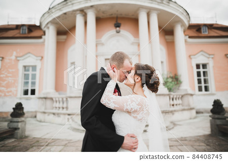 Amazing happy gentle stylish beautiful romantic caucasian couple on the background ancient baroque castle Amazing happy gentle stylish beautiful romantic caucasian couple on the background ancient baroque castle 84408745