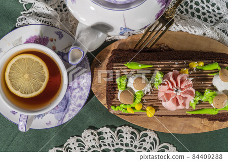 Still life with cake and a cup of tea Still life with cake and a cup of tea 84409288