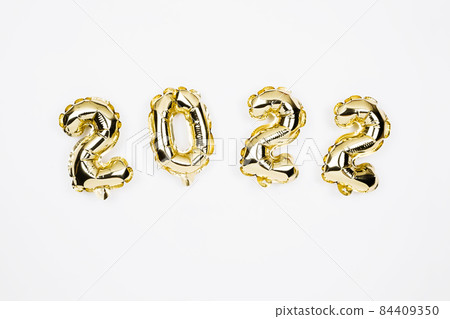 Happy New year 2022 celebration card. Gold foil balloons numeral 2022 on white background. Happy New year 2022 celebration card. Gold foil balloons numeral 2022 on white background. 84409350