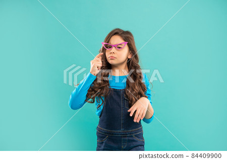 arrogant child with curly hair hold party accessory of glasses, party time arrogant child with curly hair hold party accessory of glasses, party time 84409900