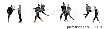 Two stylish office workers in business suits in action isolated on white background. Art, beauty, fashion and business concept 84410580