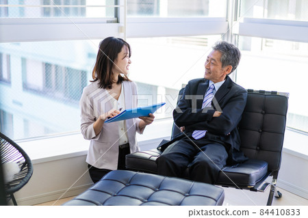The president and secretary have a meeting in the president's office The president and secretary have a meeting in the president's office 84410833