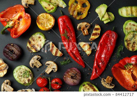 Tasty grilled vegetables on black background, top view Tasty grilled vegetables on black background, top view 84412717