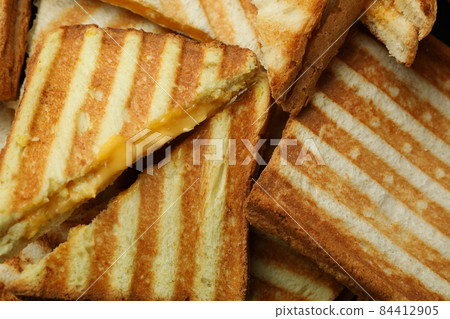 Tasty grilled sandwiches on whole background, close up Tasty grilled sandwiches on whole background, close up 84412905