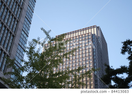 Office buildings illuminated by dusk, cityscape at sunset, skyscrapers illuminated by sunset 84413083